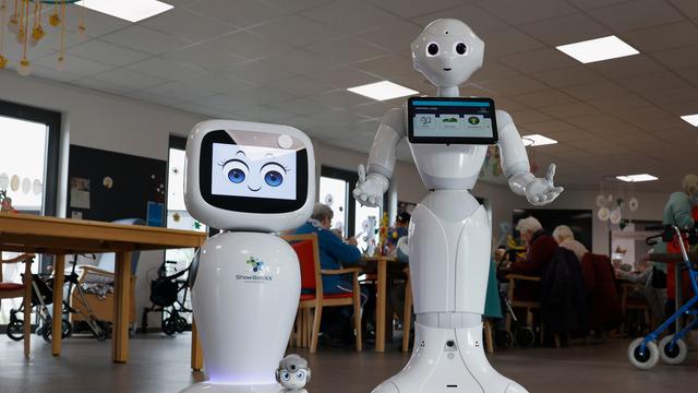 Weiß glänzende Pflegeroboter mit künstlichen Gesichtern der Firma BeckerRobotics in einem Pflegeheim